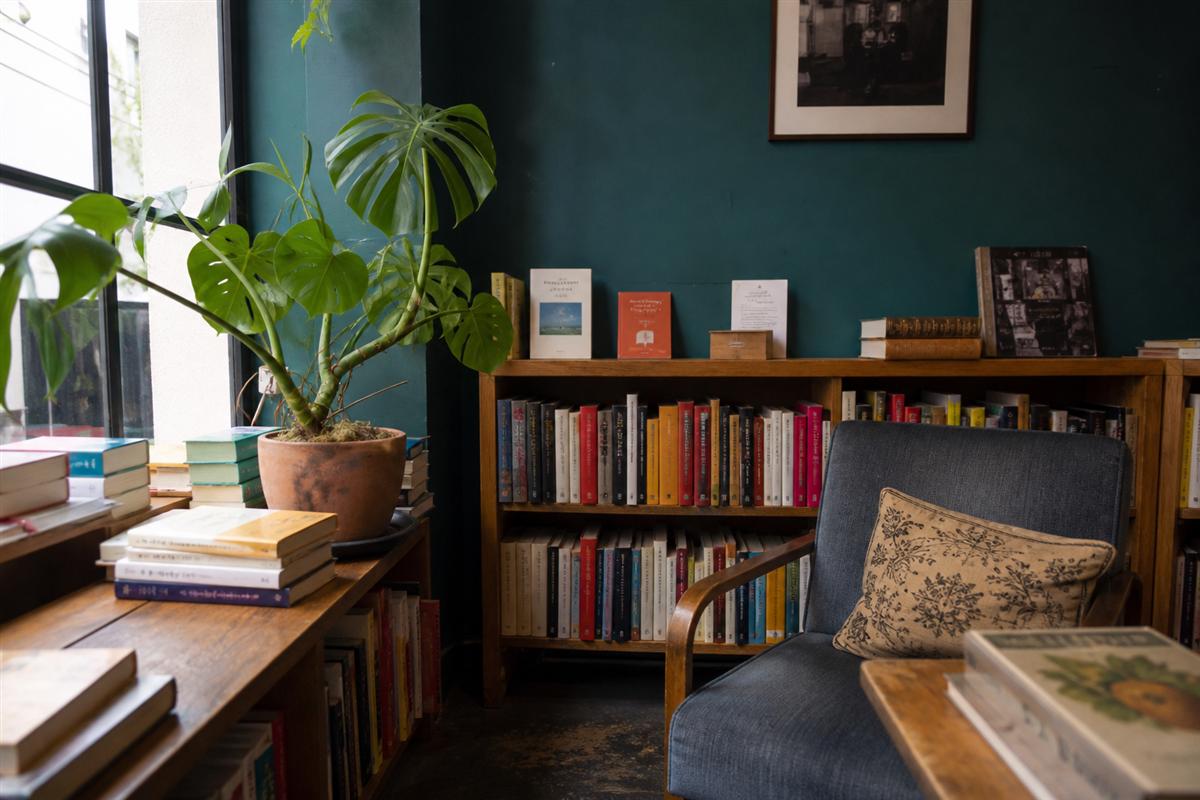 Quiet bookstore reading corner with chair and books